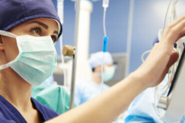 Nurse working with technology in operating room